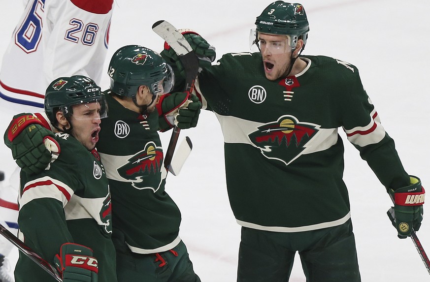 Minnesota Wild&#039;s Nino Niederreiter of Switzerland, middle, celebrates with teammates Zach Parise, left, and Charlie Coyle, right, after Niederreiter scored a goal against the Montreal Canadiens i ...