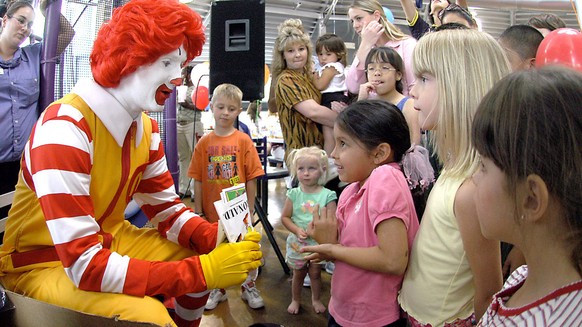 FILE - In this file photo taken May 18, 2006, Ronald McDonald visits with children at a McDonald&#039;s Restaurant in Roswell, N.M. Taco Bell is using real-life people named Ronald McDonald in a marke ...
