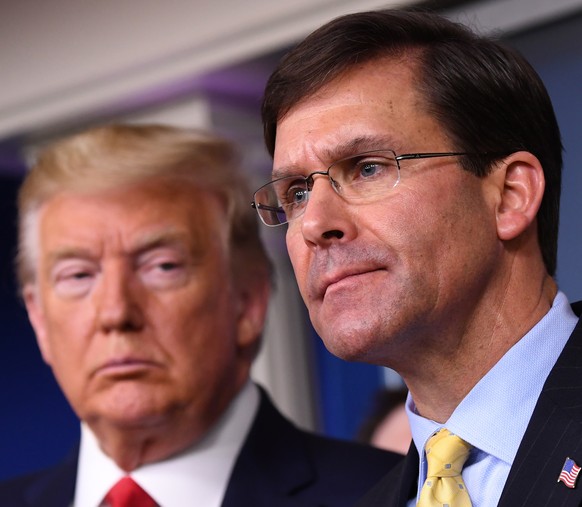 epa08810258 (FILE) - Secretary of Defense Mark Esper (R) delivers remarks on the COVID-19 (Coronavirus) pandemic as US President Donald J. Trump looks on in the Brady Press Briefing Room at the White  ...