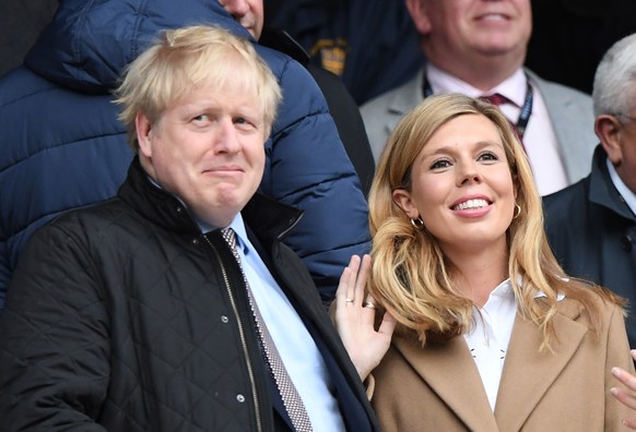 epa09236479 (FILE) - British Prime Minister, Boris Johnson and his partner Carrie Symonds ahead of the Six Nations rugby match between England and Wales held at Twickenham stadium in London, Britain,  ...