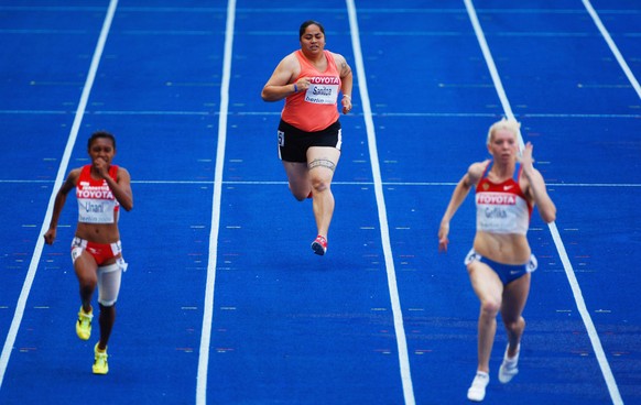 BERLIN - AUGUST 16: Savannah Sanitoa of American Samoa competes in the women&#039;s 100 Metres Heats during day two of the 12th IAAF World Athletics Championships at the Olympic Stadium on August 16,  ...