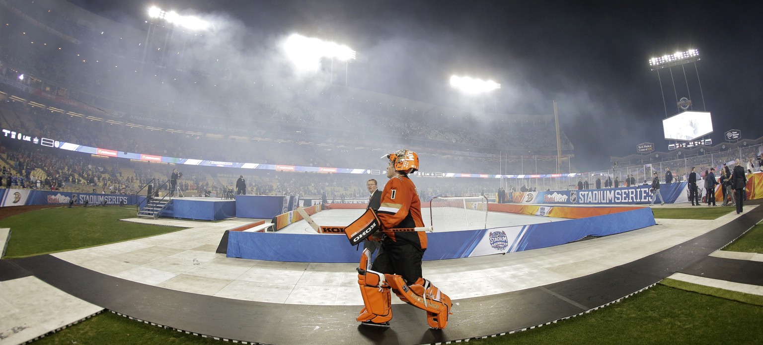 Anaheim Ducks goalie Jonas Hiller, of Switzerland, walks off the field after an NHL outdoor hockey game against the Los Angeles Kings at Dodger Stadium in Los Angeles, Saturday, Jan. 25, 2014. (AP Pho ...