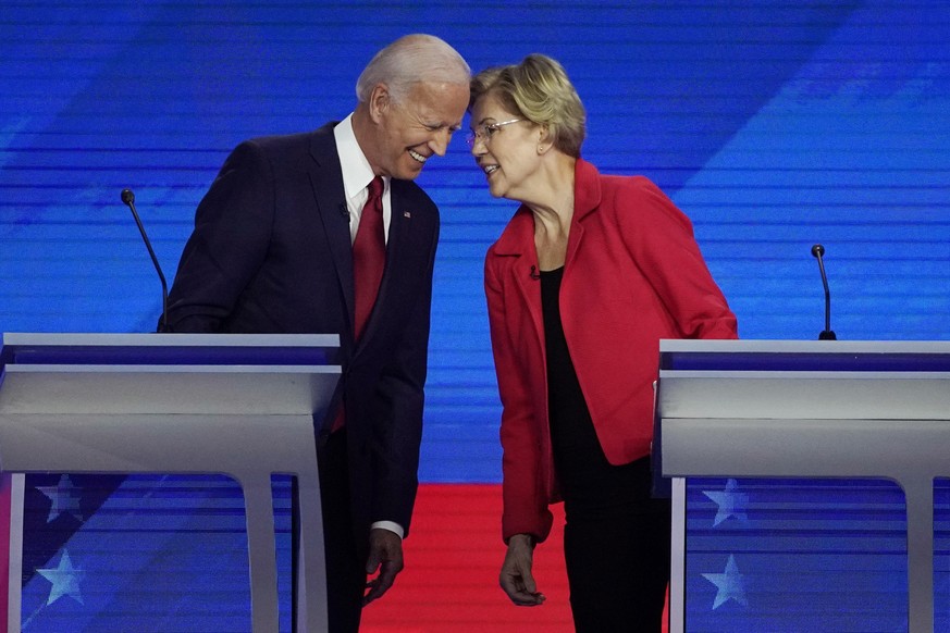 FILE - In this Sept. 12, 2019, file photo Democratic presidential candidates former Vice President Joe Biden, left and Sen. Elizabeth Warren, D-Mass., talk during a Democratic presidential primary deb ...