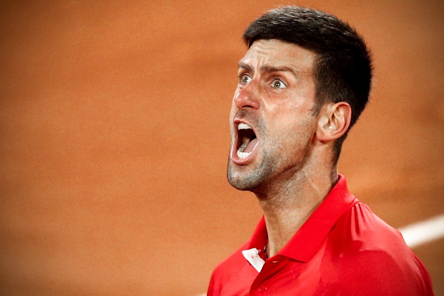 epa09258768 Novak Djokovic of Serbia reacts after winning his quarter final match against Matteo Berrettini of Italy at the French Open tennis tournament at Roland Garros in Paris, France, 09 June 202 ...