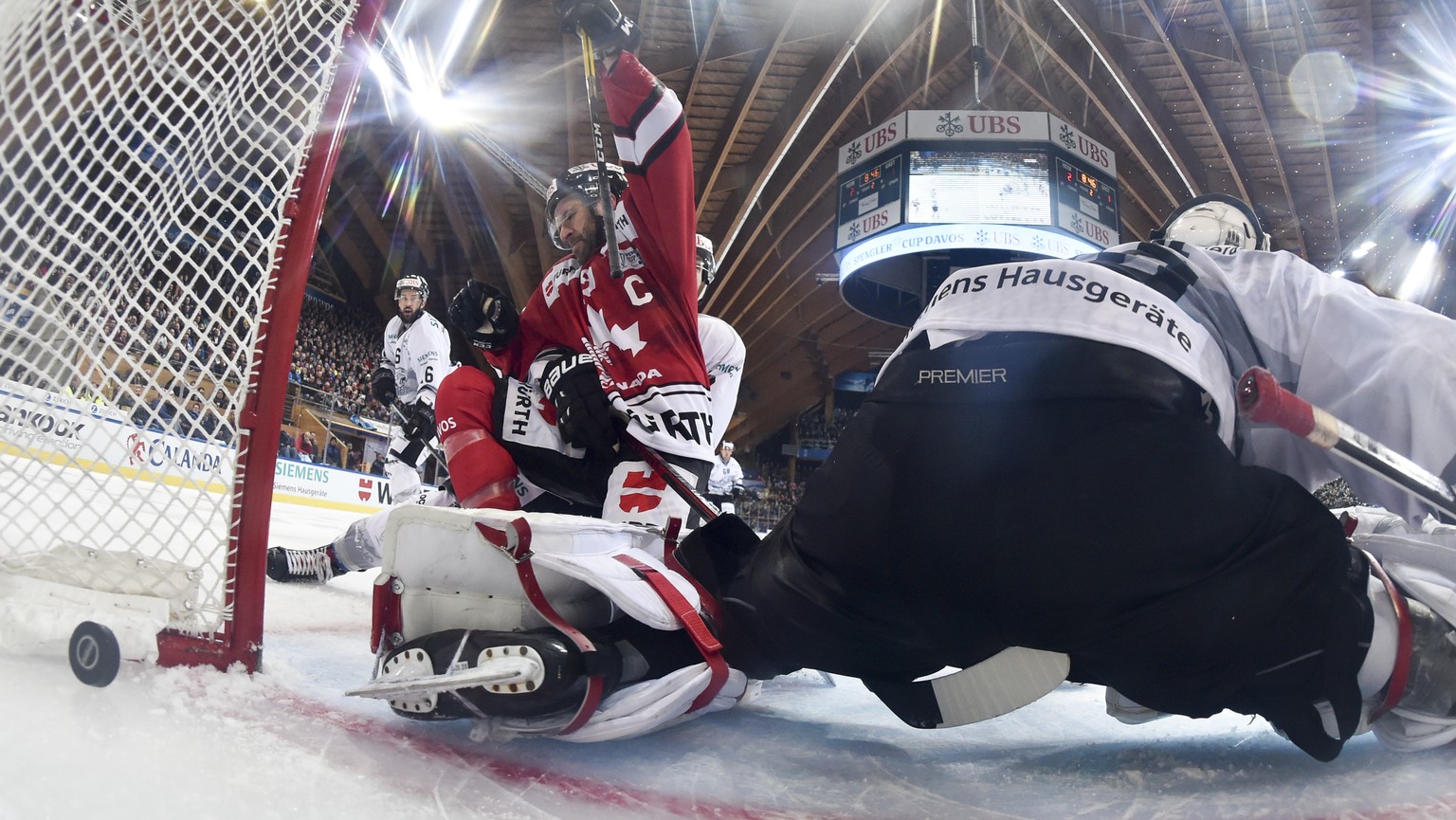 Team Canada&#039;s Andrew Ebbet scores 3-1 versus Ice Tigers`s goalkeeper Andreas Jenik during the game between Team Canada and Thomas Sabo Ice Tigers at the 92th Spengler Cup ice hockey tournament in ...
