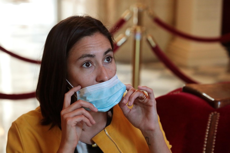 epa08432144 Member of the French National Assembly and former member of La Republique Em Marche (LREM) Paula Forteza wears a protective facial mask as she speaks with journalists ahead of a parliament ...