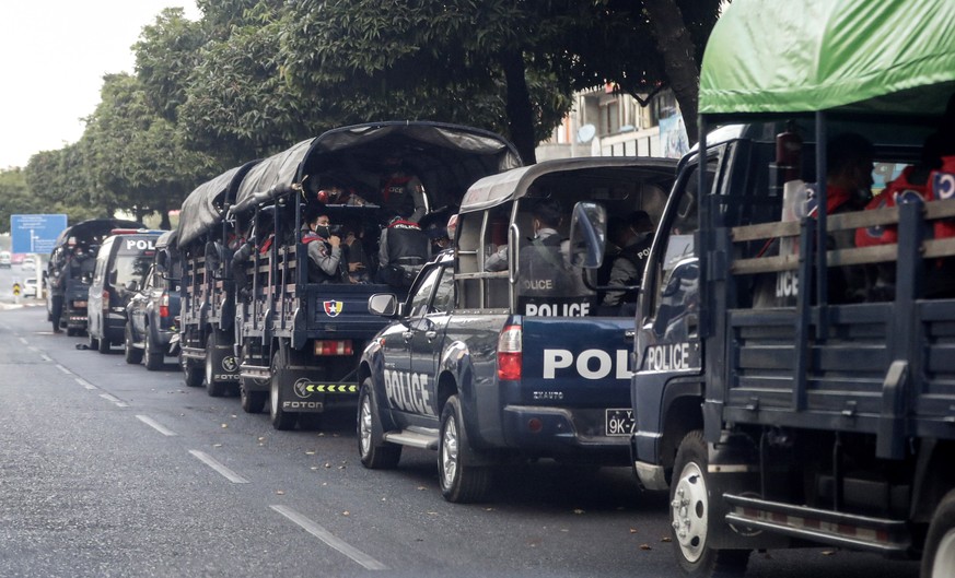 epa08979685 Vehicles carrying police officers park at Sule Pagoda Road in Yangon, Myanmar, 01 February 2021. The army said that the senior members of the National League for Democracy (NLD), including ...
