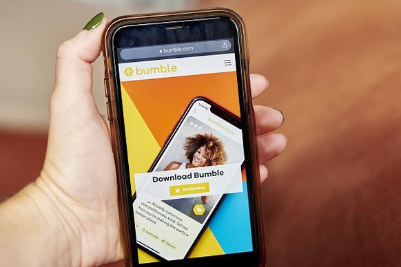 The website home screen for Bumble is displayed on a smartphone in an arranged photograph taken in the Brooklyn borough of New York, U.S., on Friday, Oct. 9, 2020. Blackstone Group, which bought a maj ...