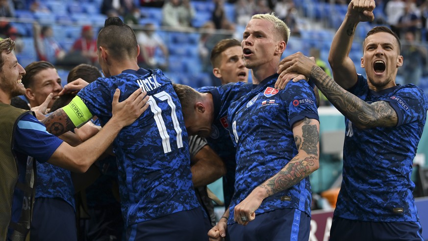 Slovakia&#039;s Milan Skriniar celebrates with teammates after scoring his side&#039;s second goal during the Euro 2020 soccer championship group E match between Poland v Slovakia at the Saint Petersb ...