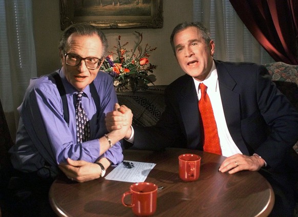 FILE - In this Dec. 16, 1999 file photo, Republican presidential candidate Texas Gov. George W. Bush jokes with CNN&#039;s Larry King after finishing the &quot;Larry King Live&quot; show from the Wild ...
