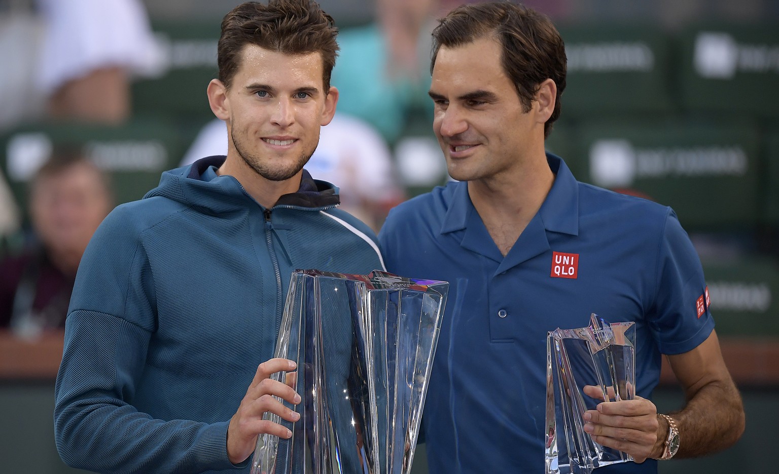 Dominic Thiem, of Austria, left, and Roger Federer, of Switzerland, pose with trophies after Thiem defeated Federer in the men&#039;s final at the BNP Paribas Open tennis tournament Sunday, March 17,  ...