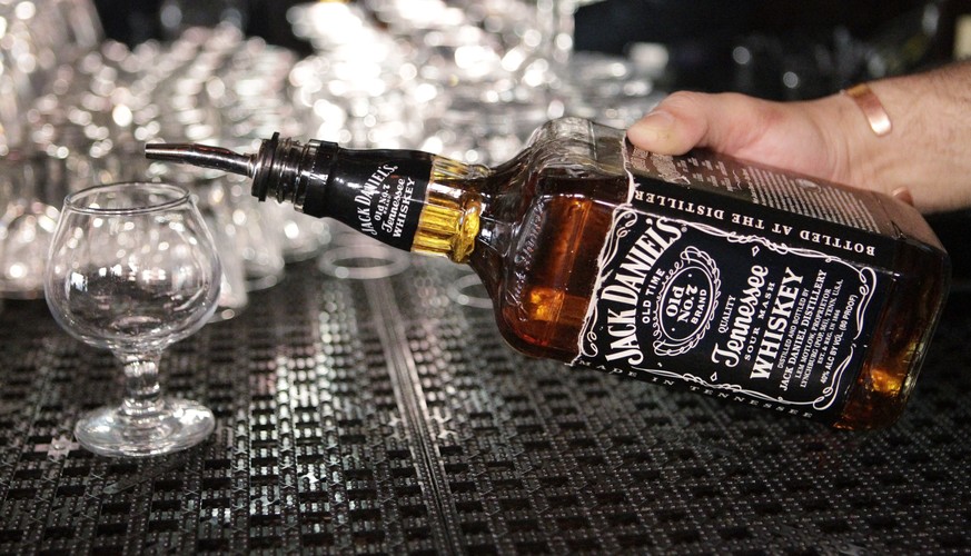 FILE - In this March 4, 2011, file photo, a bartender begins to pour a drink from a bottle of Jack Daniels at a bar in San Francisco. Spirits maker Brown-Forman Corp. (BF.A) on Wednesday, June 7, 2017 ...