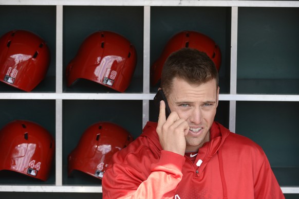 FILE - In this April 1, 2013, file photo, Los Angeles Angels outfielder Mike Trout talks on a cell phone in the dugout at Great American Ball Park in Cincinnati. Baseball is an atypical workplace but  ...