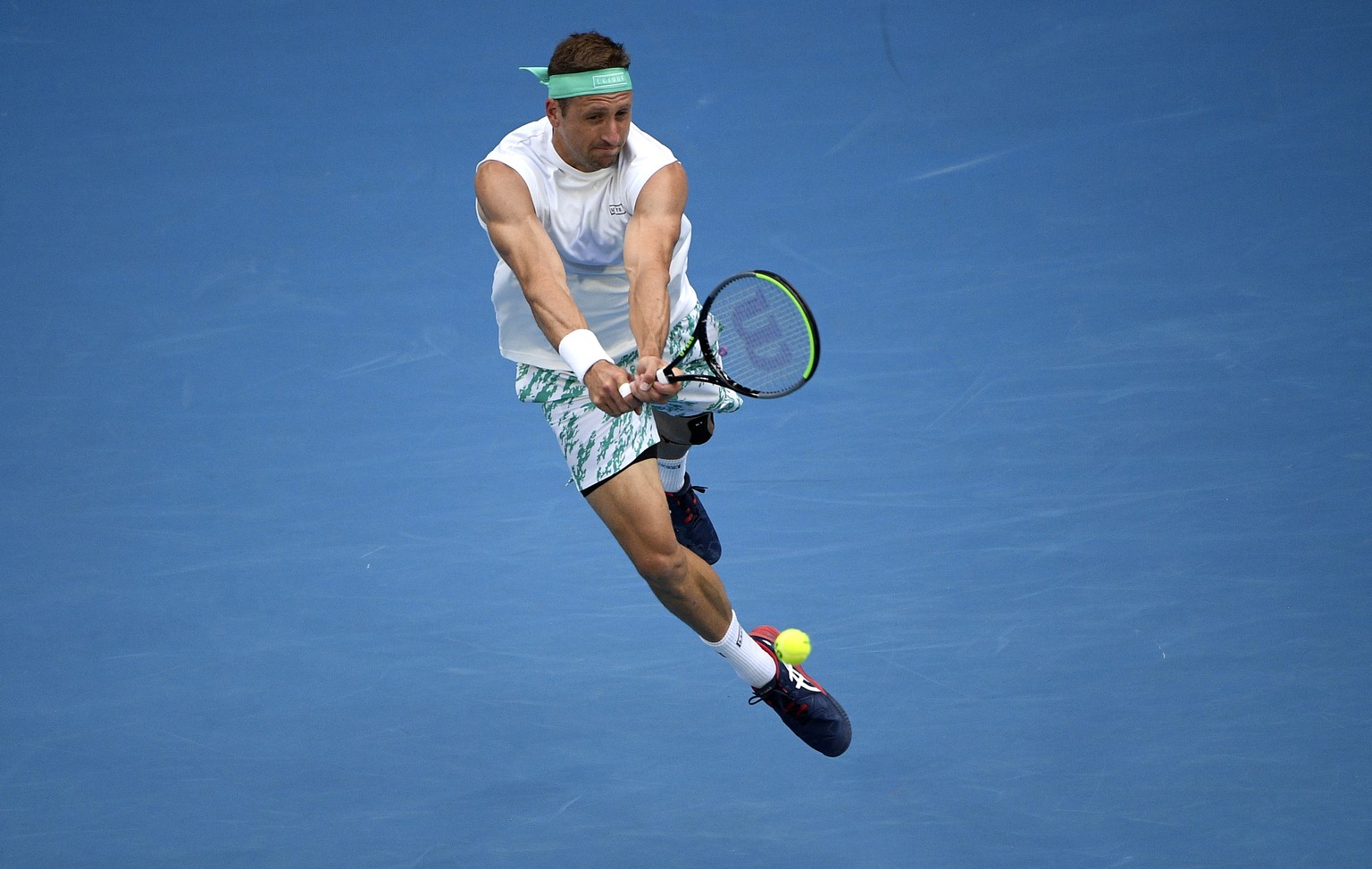 Tennys Sandgren of the U.S. makes a backhand return to Italy&#039;s Fabio Fognini during their fourth round singles match at the Australian Open tennis championship in Melbourne, Australia, Sunday, Ja ...
