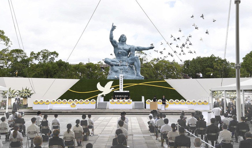 Doves fly over the Statue of Peace during a ceremony at Nagasaki Peace Park in Nagasaki, southern Japan, Sunday, Aug. 9, 2020, to mark the 75th anniversary of the world&#039;s second atomic bomb attac ...