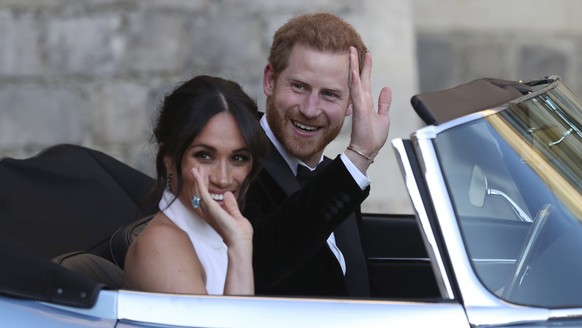 FILE - In this Saturday, May 19, 2018 file photo the newly married Duke and Duchess of Sussex, Meghan Markle and Prince Harry, leave Windsor Castle in a convertible car after their wedding in Windsor, ...