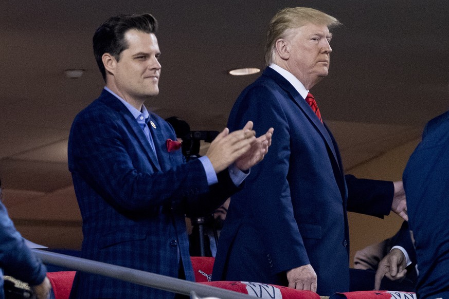 FILE - In this Oct. 27, 2019, file photo President Donald Trump, right, accompanied by Rep. Matt Gaetz, R-Fla., left, arrive for Game 5 of the World Series baseball game between the Houston Astros and ...
