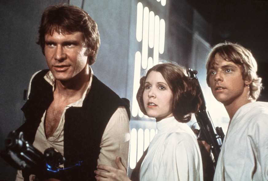 In this 1977 image provided by 20th Century-Fox Film Corporation, from left, Harrison Ford, Carrie Fisher, and Mark Hamill are shown in a scene from &quot;Star Wars&quot; movie released by 20th Centur ...