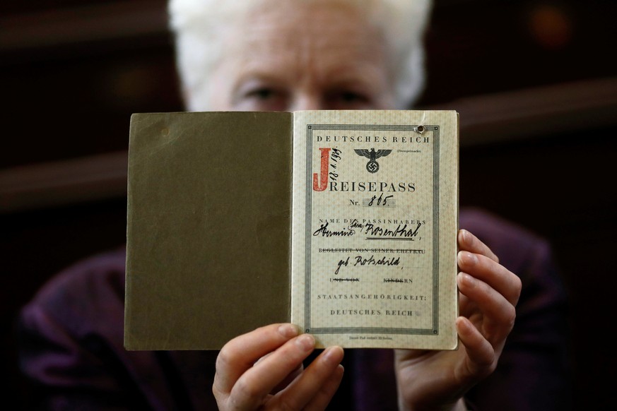 London rabbi Julia Neuberger poses for a photograph with the old German passport of her grandmother, Hermine Sara Rosenthal, at the West London Synagogue in London, Britain September 20, 2016. REUTERS ...