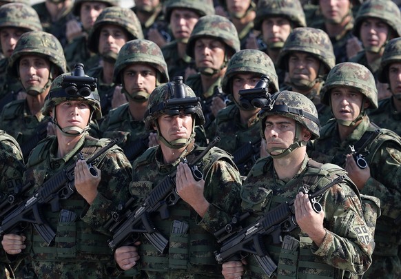 In this photo taken Saturday, Oct. 19, 2019, Serbian Army soldiers perform during a military parade at the military airport Batajnica, near Belgrade, Serbia. Citing alleged pressure from the West, Ser ...