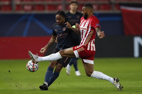 Manchester City&#039;s Raheem Sterling , left, fights for the ball with Olympiacos&#039; Yann M&#039;Vila During the Champions League, group C soccer match between Olympiacos and Manchester City at Ge ...