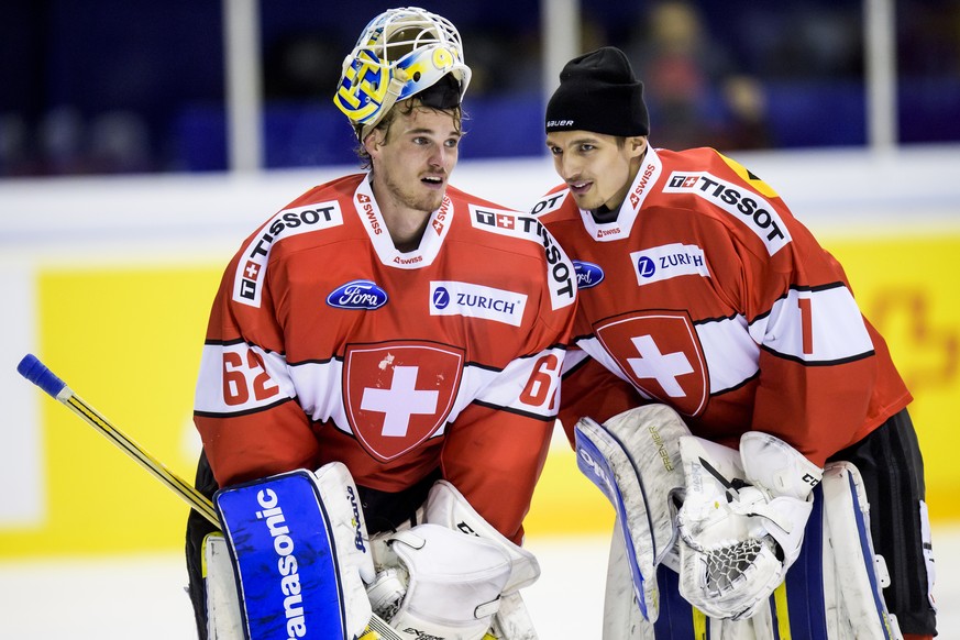 Switzerland&#039;s goaltender Gilles Senn, left, reacts with Switzerland&#039;s goaltender Joren Van Pottelberghe, right, during a friendly game between Switzerland and Belarus, at the Ice stadium Les ...
