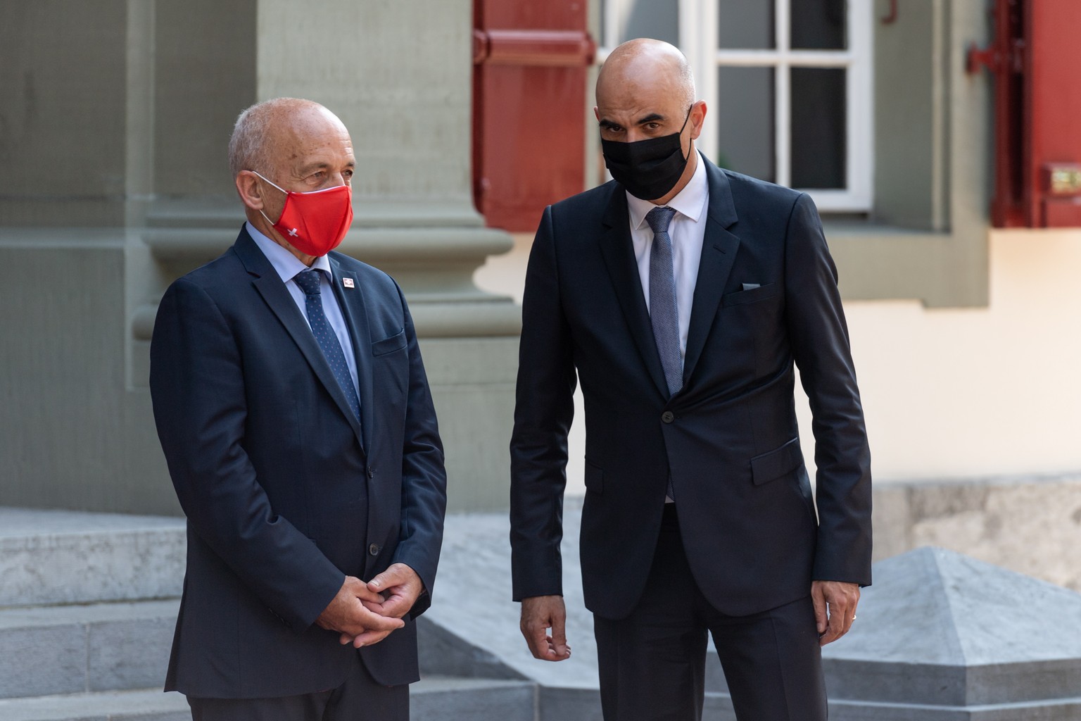 epa08678489 Swiss Federal councillors Ueli Maurer (L) and Alain Berset (R) wait for the arrival of Austrian Chancellor Sebastian Kurz at the Lohn residence of the Swiss government, in Kehrsatz near Be ...