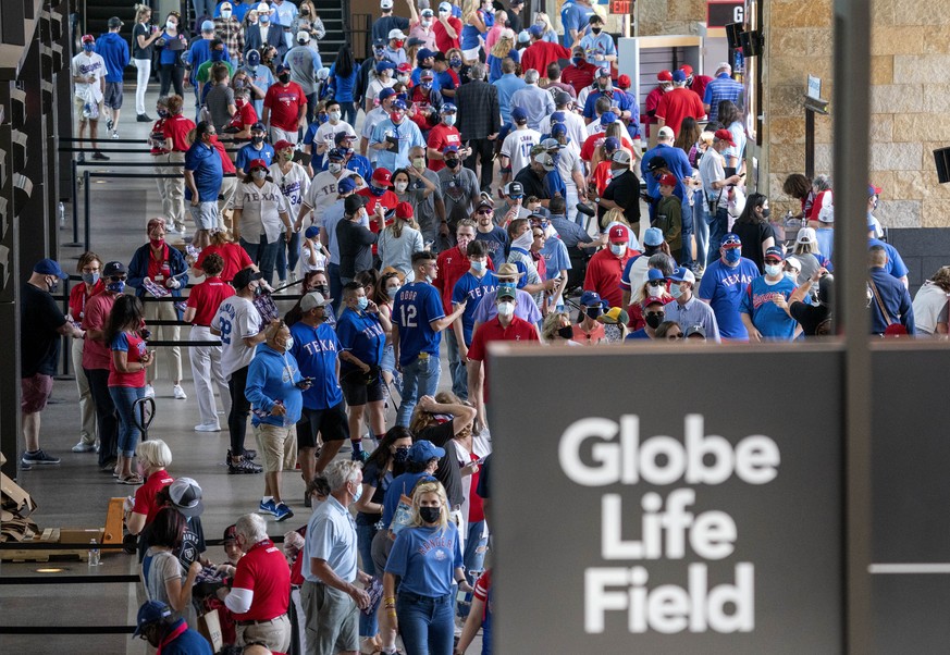 Fans walk through the main concourse of Globe Life Field before the Texas Rangers home opener baseball game against the Toronto Blue Jays on Monday, April 5, 2021, in Arlington, Texas. The Texas Range ...