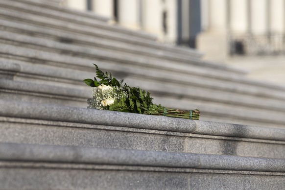 epa08933135 Flowers are seen placed on the steps of the US House of Representatives at the East Front of the US Capitol in Washington, DC, USA, 12 January 2021. At least ten thousand troops of the Nat ...