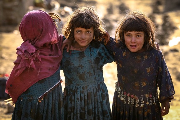 epa08831444 Afghan internally displaced children pose for a photograph as they play outside a temporary shelter on the occasion of Universal Children&#039;s Day in Kabul, Afghanistan on 20 November 20 ...