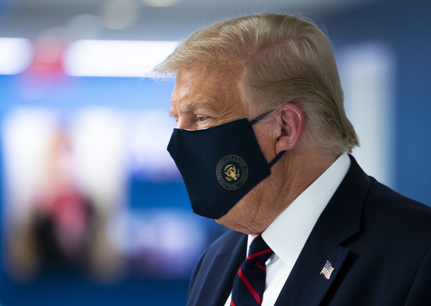 President Donald Trump wears a face mask as he tours the American Red Cross national headquarters in Washington, Thursday, July 30, 2020. (Doug Mills/The New York Times via AP, Pool)