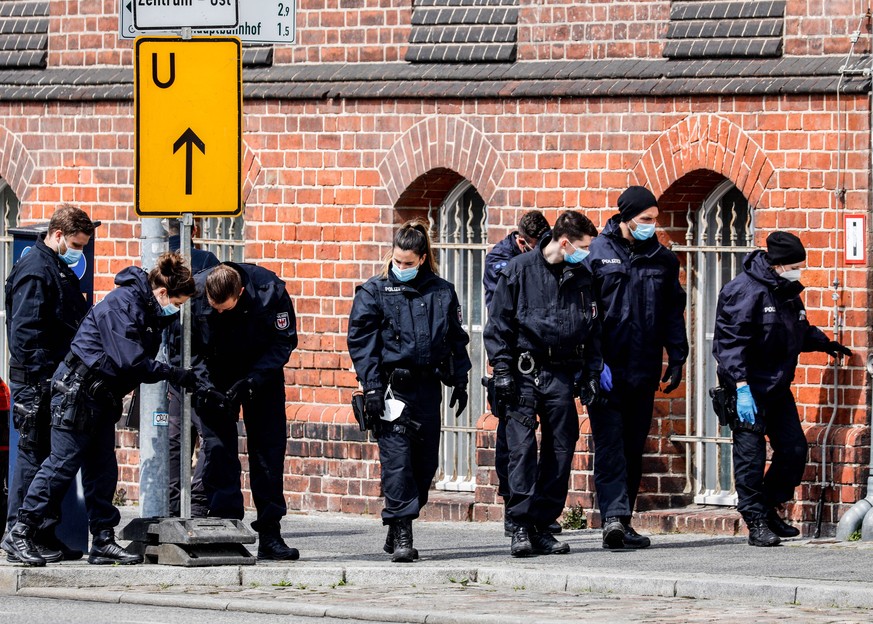 epa09167584 Police investigate in front of Oberlin care Clinic in Potsdam, Germany, 29 April 2021. German police arrested a woman on suspicion of killing four people on late evening of 28 April. EPA/F ...