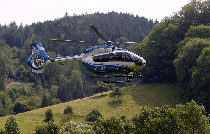 epa08545618 German police is searching for a man armed with knives and pistols with a helicopter in a forest area north of Oppenau near Offenburg, Germany, 14 July 2020. According to the police, the s ...