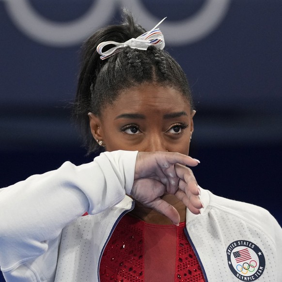 Simone Biles, of the United States, watches gymnasts perform after an apparent injury, at the 2020 Summer Olympics, Tuesday, July 27, 2021, in Tokyo. Biles withdrew from the team finals. (AP Photo/Ash ...