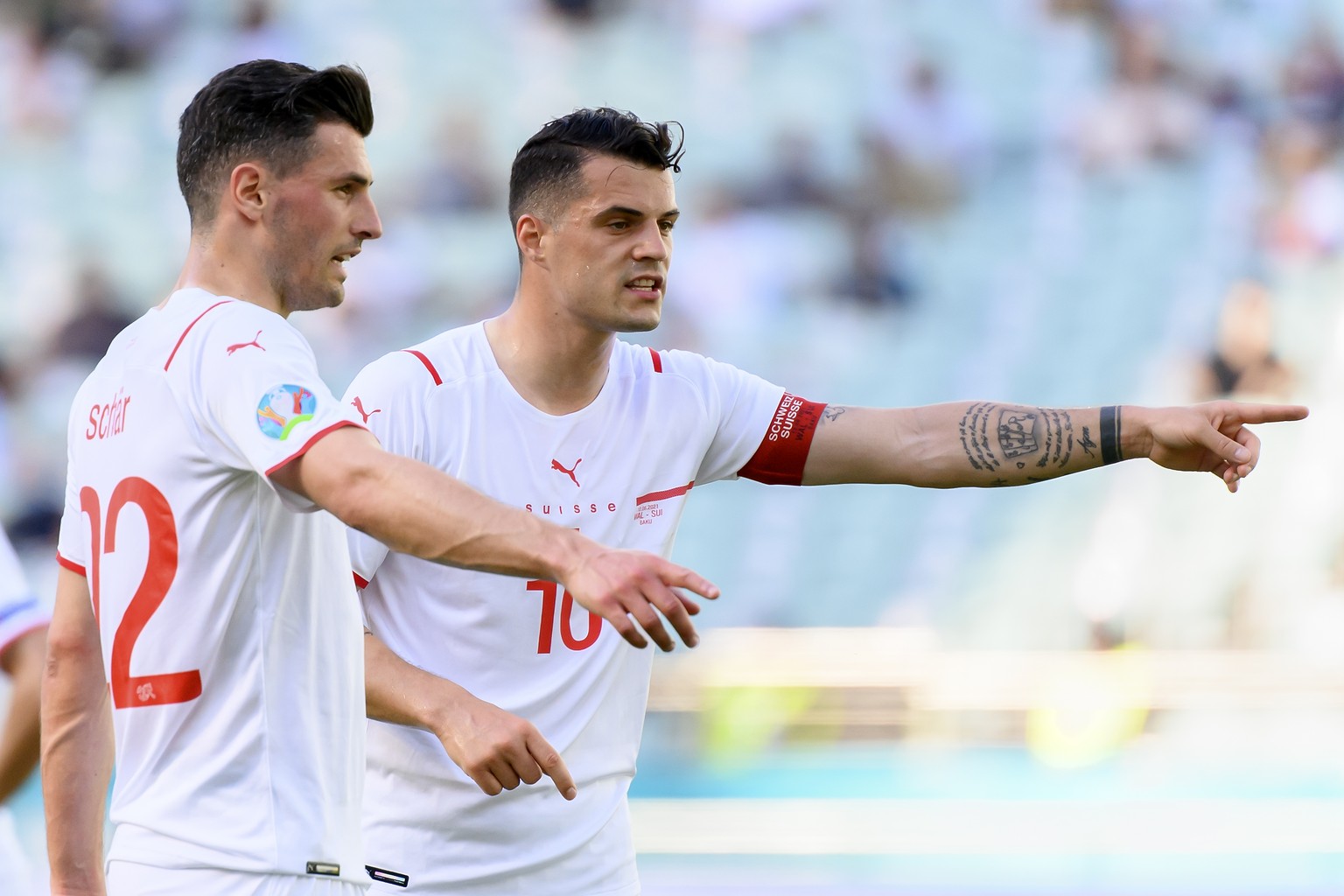 Switzerland&#039;s defender Fabian Schaer, left, and Switzerland&#039;s midfielder Granit Xhaka, right, react during during the Euro 2020 soccer tournament group A match between Wales and Switzerland  ...