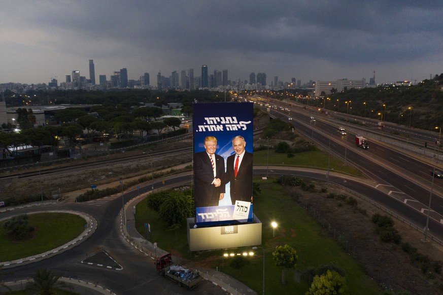 A massive election campaign billboard of the Likud party shows Israeli Prime Minister Benjamin Netanyahu, right, and US President Donald Trump in Tel Aviv, Israel, Sunday, Sept 8, 2019. Hebrew on the  ...