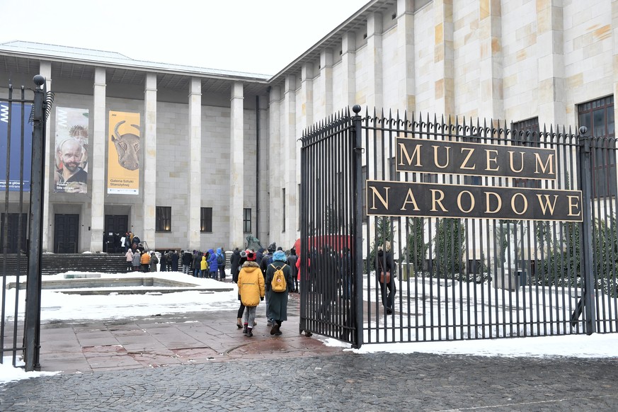 epa08981587 People queue to the entrance of the National Museum in Warsaw, Poland, 02 February 2021. Poland decided to reopen its museums and some cultural institutions from 01 February, but extended  ...