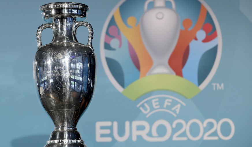 FILE - In this Thursday, Oct. 27, 2016 file photo the Euro soccer championships trophy is seen in front of the logo during the presentation of Munich&#039;s logo as one of the host cities of the Euro  ...