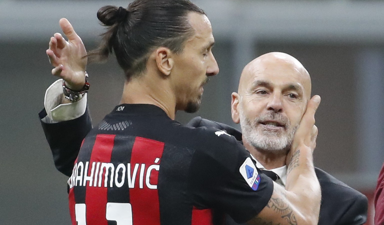 FILE - In this Saturday, Oc.t 17, 2020 file photo, AC Milan manager Stefano Pioli, right, congratulates Zlatan Ibrahimovic at the end of the Serie A soccer match between Inter Milan and AC Milan at th ...