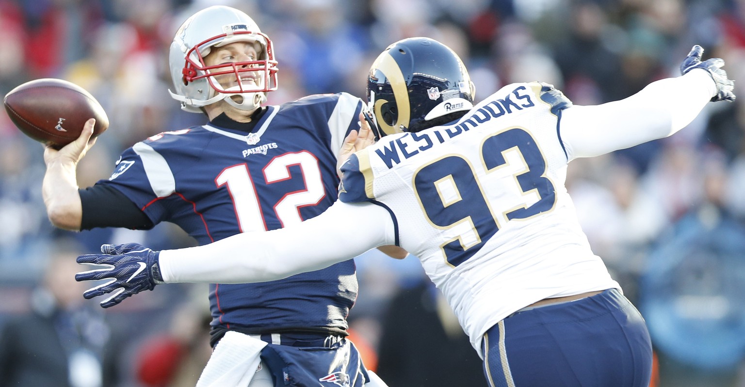 Dec 4, 2016; Foxborough, MA, USA; New England Patriots quarterback Tom Brady (12) makes a pass as Los Angeles Rams defensive end Ethan Westbrooks (93) defends during the third quarter at Gillette Stad ...