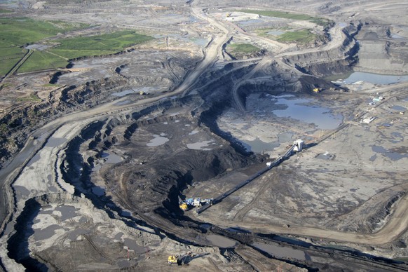 FILE - This June 25, 2008 photo shows an aerial view just north of Fort McMurray in Alberta, Canada, where the world&#039;s largest oil companies are building massive open pit mines to get at the oil  ...