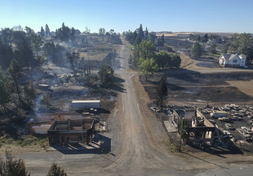 In downtown Malden, Washington, the former post office at lower left and another historic building at lower right still smolder Tuesday, Sept. 8, 2020, the day after a fast-moving wildfire swept throu ...