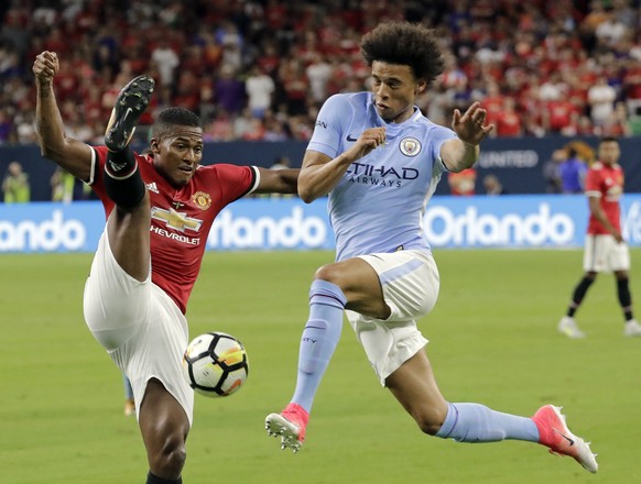 Manchester United&#039;s Luis Antonio Valencia, left, tries to block a drive by Manchester City&#039;s Leroy Sane, right, during the second half of an International Champions Cup soccer match in Houst ...