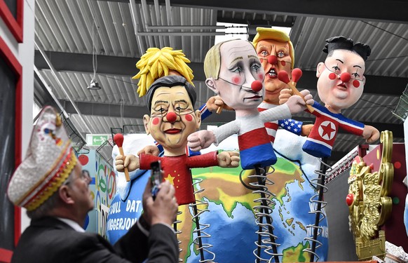 A satiric carnival float depicting the leaders of China, United Kingdom, Russia, USA and North Korea, Xi Jinping, Boris Johnson, Vladimir Putin, Donald Trump and Kim Jong-un as puppets is watched by a ...