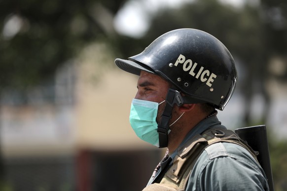 A policeman wearing a face mask to help curb the spread of the coronavirus stands guard in a street in Kabul, Afghanistan. Monday, May 10, 2021. (AP Photo/Rahmat Gul)