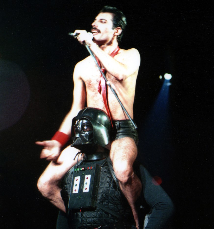 HOUSTON - AUGUST 10: British singer, songwriter and lead vocalist of the rock band Queen, Freddie Mercury, sits on the shoulders of Darth Vader as they perform their encore during &quot;The Game&quot; ...