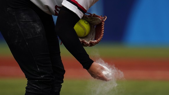 Canada&#039;s Danielle Lawrie squeezes a rosin bag while pitching during a softball game against Italy at Yokohama Baseball Stadium during the 2020 Summer Olympics, Monday, July 26, 2021, in Yokohama, ...