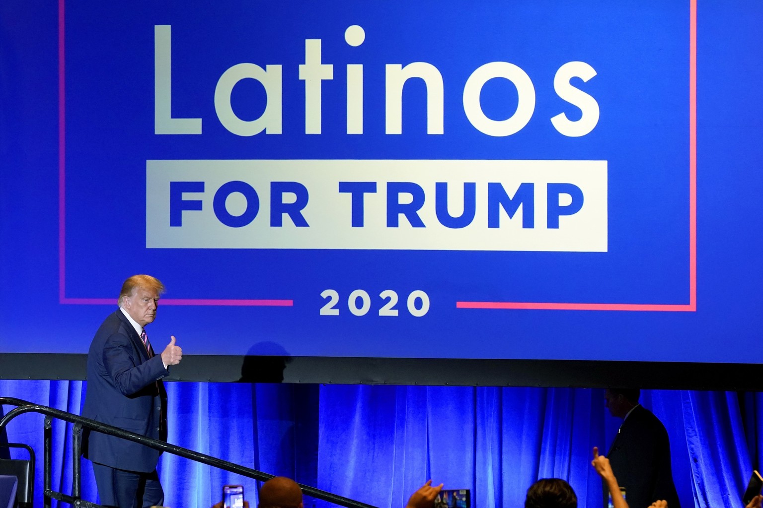 FILE - In this Sept. 14, 2020 file photo, President Donald Trump give a thumbs up to the cheering crowd after a Latinos for Trump Coalition roundtable in Phoenix. President Donald Trump is putting up  ...