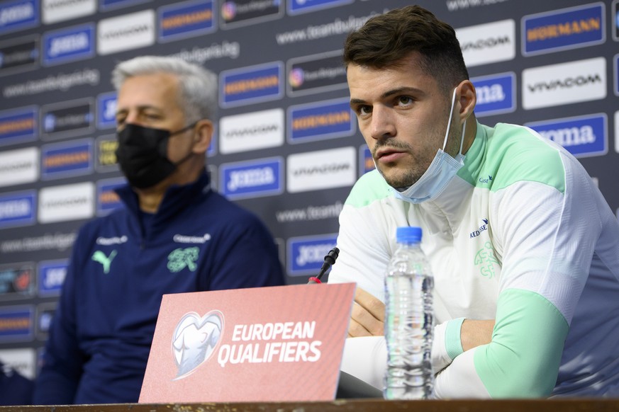 Switzerland&#039;s national soccer team head coach Vladimir Petkovic, left, and Switzerland&#039;s national team soccer player Granit Xhaka, right, speak at a press conference before a training sessio ...