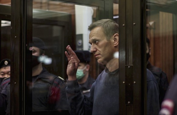 epa08982535 A handout picture provided by Moscow City court press service shows Russian opposition leader Alexei Navalny stands in the glass cage during a hearing in the Moscow City Court in Moscow, R ...
